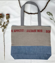 Load image into Gallery viewer, Tote Bag. 100% French linen fabric « Bon appétit » with a light blue denim bottom.
