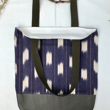 Load image into Gallery viewer, Tote bag. Ikat pattern fabric with a khaki green leather round bottom.
