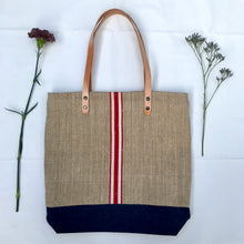 Load image into Gallery viewer, Tote bag. Vintage grain sack tote bag with brown leather straps. Handwoven. Vertical red and leather white stripes.
