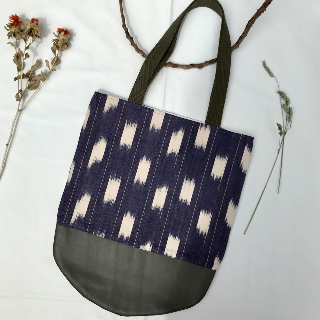 Tote bag. Ikat pattern fabric with a khaki green leather round bottom.