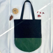 Load image into Gallery viewer, Tote bag. Dark grey wool tote with a green leather round bottom.

