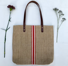 Load image into Gallery viewer, Tote bag. Vintage grain sack tote bag with brown leather straps. Handwoven. Vertical red and leather white stripes.
