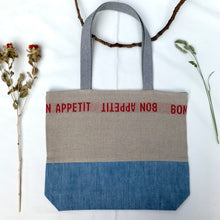 Load image into Gallery viewer, Tote Bag. 100% French linen fabric « Bon appétit » with a light blue denim bottom.
