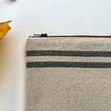 Load image into Gallery viewer, Cream woven canvas pouch with two horizontal grey stripes. YKK zip. Zippered purse. Zippered pouch. YKK zipper.
