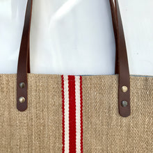 Load image into Gallery viewer, Tote bag. Vintage grain sack tote bag with brown leather straps. Handwoven. Vertical red and leather white stripes.
